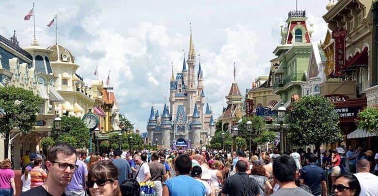Cinderella Castle at Magic Kingdom as seen from Main Street, U.S.A. with a Disney bus arriving at the station.