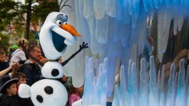 Olaf waving from the Frozen Ever After float at Disney World.