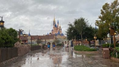 Cinderella Castle at Magic Kingdom under a cloudy Florida sky.