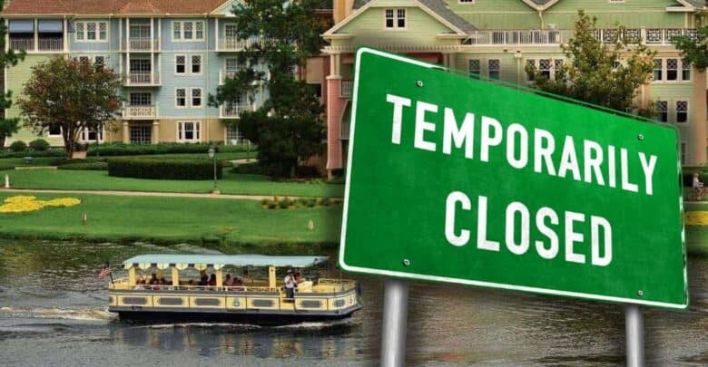A green Temporarily Closed sign in front of a Disney’s Old Key West Resort lake with a Friendship boat.