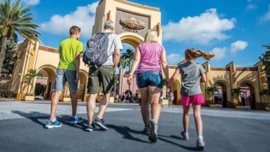 A family walks toward the Universal Orlando entrance.