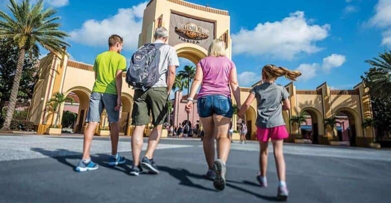 A family walks toward the Universal Orlando entrance.