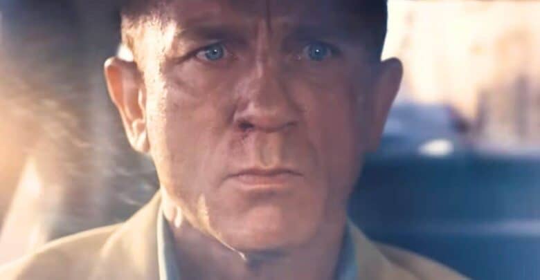 James Bond driving with a serious expression.