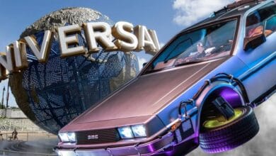 The DeLorean time machine flying in front of the Universal Orlando globe.