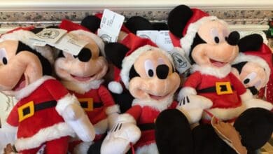 Santa Mickey Mouse plush toys available for mobile checkout at Disney World.