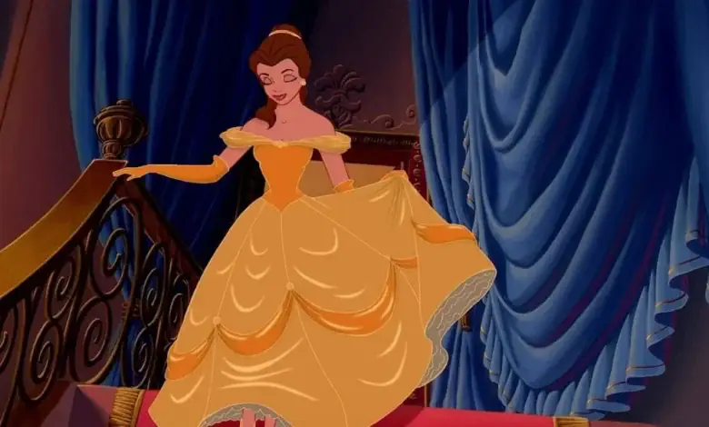 Belle descending the staircase in her iconic yellow ball gown at a Disney park.