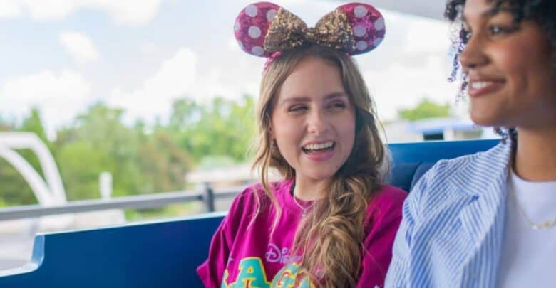 Two women smiling while riding the Tomorrowland PeopleMover at Magic Kingdom.
