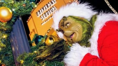 The Grinch in his Santa suit meeting guests at Universal Studios.