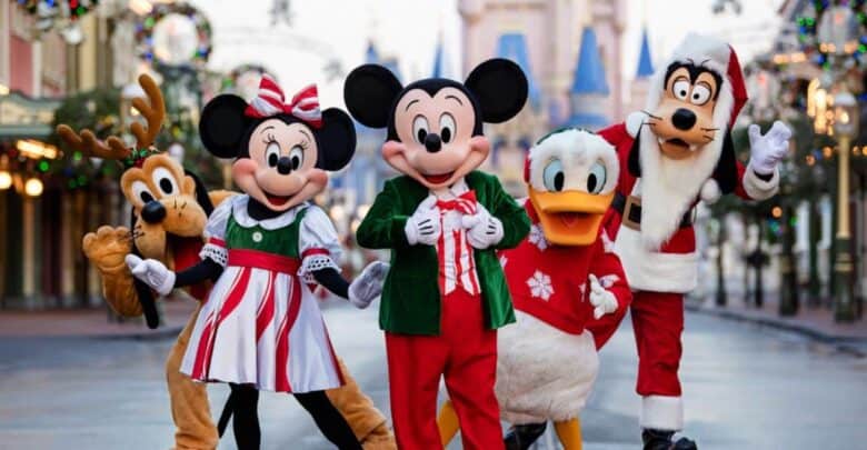 Pluto, Minnie, Mickey, Donald, and Goofy in holiday outfits on Main Street, U.S.A. during Mickey’s Very Merry Christmas Party at Walt Disney World.