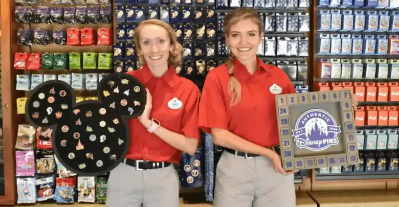 Two Disney World cast members hold a Mickey-shaped board and an advent-style display for Disney mystery pins.