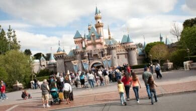 Guests walk toward the entrance of Sleeping Beauty Castle at Disneyland.