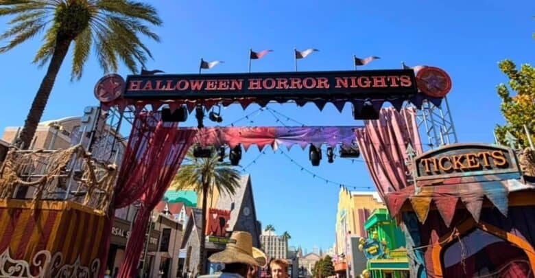 Halloween Horror Nights entrance archway at Universal Studios featuring a park rules broadcast warning.