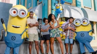 A family posing with two Minions at Universal Studios, which you can visit with a Universal discount.