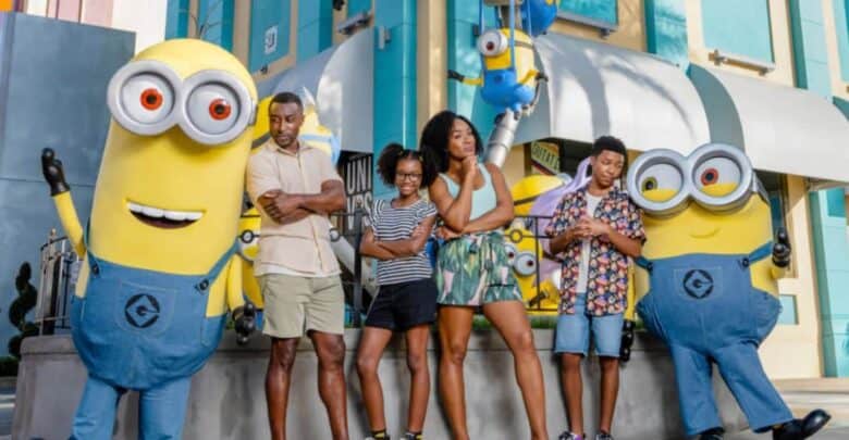 A family posing with two Minions at Universal Studios, which you can visit with a Universal discount.